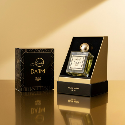 DA'IM oud perfume bottle and packaging on a reflective surface with a warm beige background - Fragrance notes of Da’im Oud by Leesh Fragrances — featuring saffron, jasmine, lemon, and bergamot at the top; rose, amberwood, and ylang-ylang at the heart; and a rich base of agarwood oud, musk, patchouli, sandalwood, cedar, and cinnamon.
