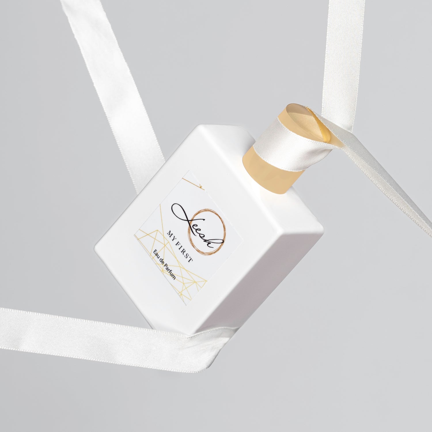 Her First perfume bottle elegantly displayed, featuring sweet vanilla, jasmine, and cedarwood notes for a timeless, feminine scent.