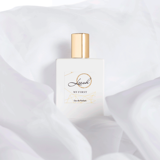 Her First perfume bottle with delicate details, a luxurious scent blending patchouli, jasmine, and vanilla for unforgettable memories.