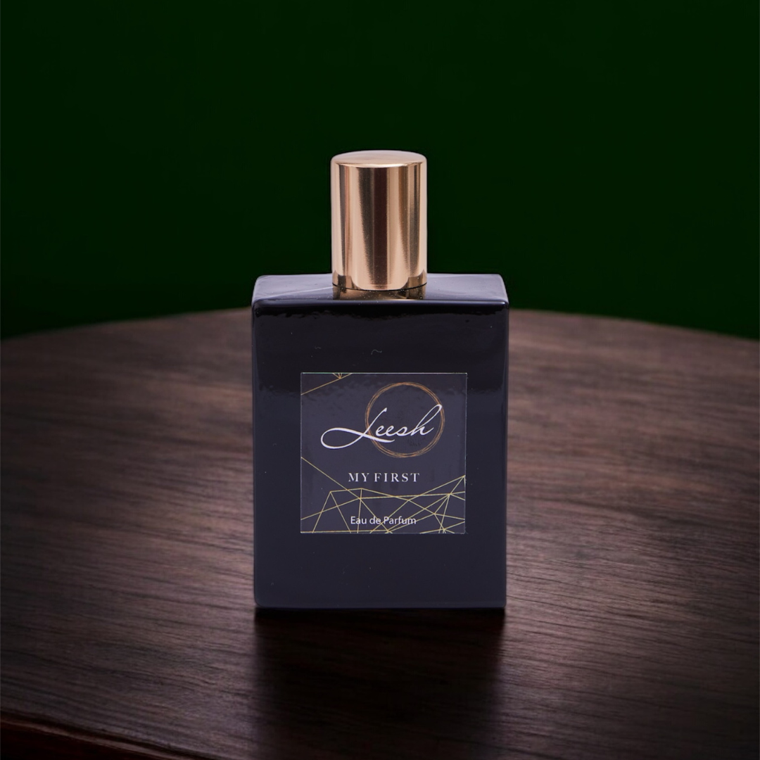 His My First by Leesh — a bold and confident fragrance for men. Featuring cedarwood, amber, bergamot, and black pepper, designed to celebrate life’s unforgettable firsts. Elegant bottle shot with warm amber lighting, reflecting sophistication and strength.
