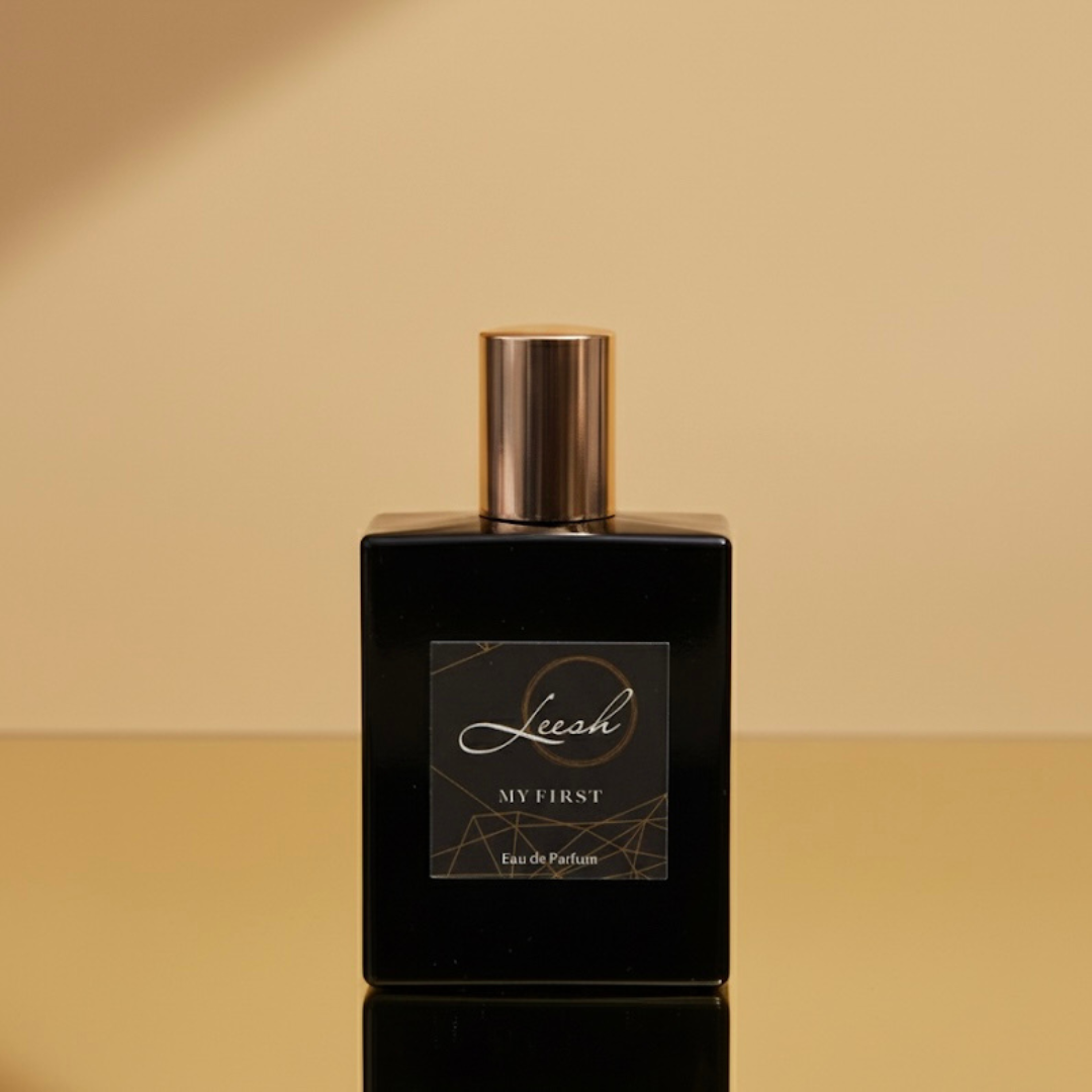 His My First by Leesh — a bold and confident fragrance for men. Featuring cedarwood, amber, bergamot, and black pepper, designed to celebrate life’s unforgettable firsts. Elegant bottle shot with warm amber lighting, reflecting sophistication and strength.
