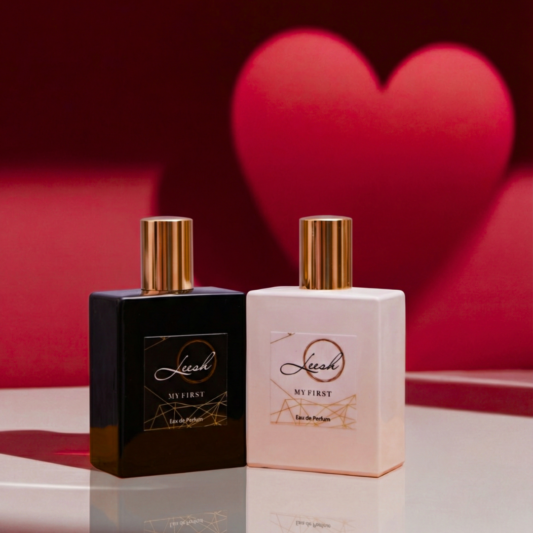Two perfume bottles with gold caps on a reflective surface, heart-shaped background. My First His and Hers fragrances by Leesh Fragrances displayed together on a white surface with a red background and heart-shaped shadow for Valentine’s Day.